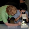 Student with Microscope 100x100 Group Tours & Educators